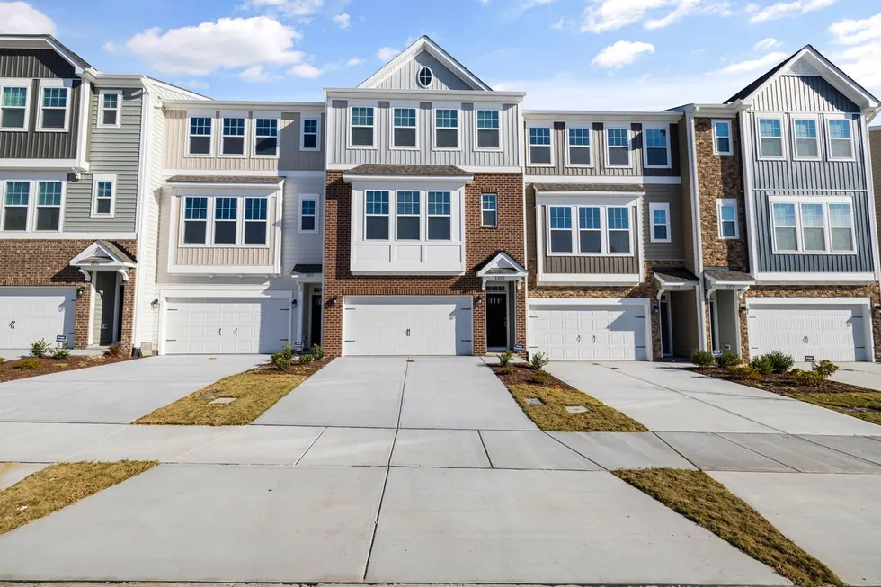 Row of new townhomes with concrete driveways